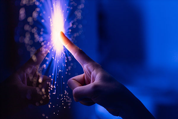 Fingers touching a screen creating a Spark, representing Spark AI