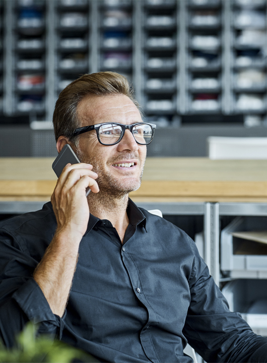 Man talking on mobile phone in office