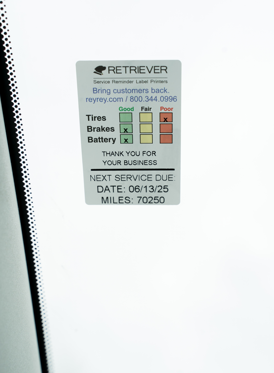 retriever service reminder label inside a vehicle on the window